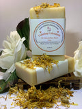 Bar of soap with a label on a decorative background with flowers and herbs