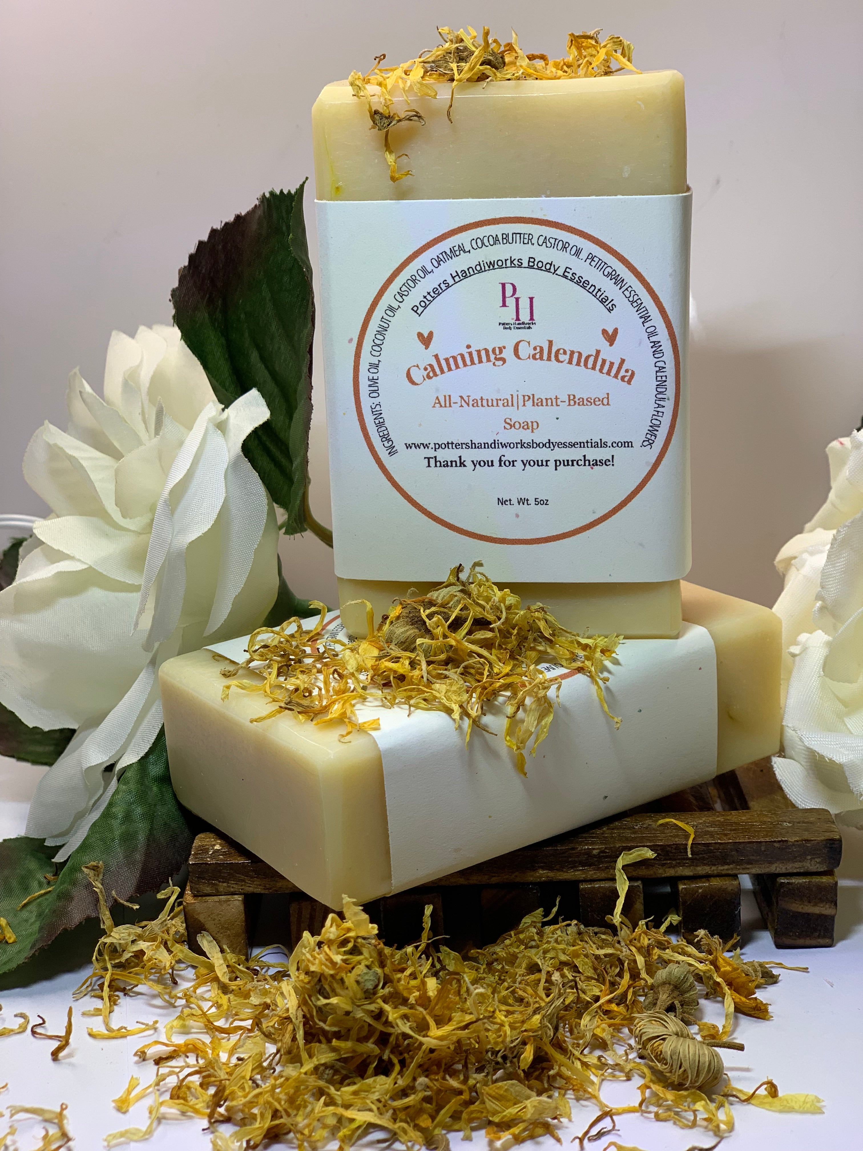 Bar of soap with a label on a decorative background with flowers and herbs