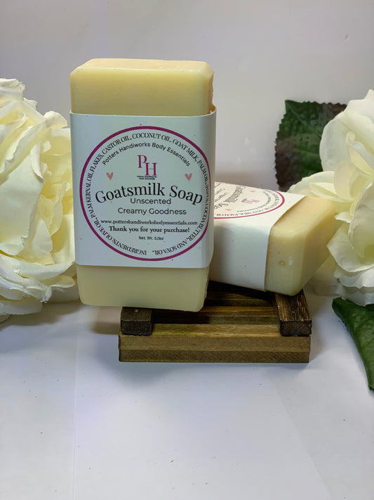 Goatsmilk soap bar with a decorative stand and flowers on a white background